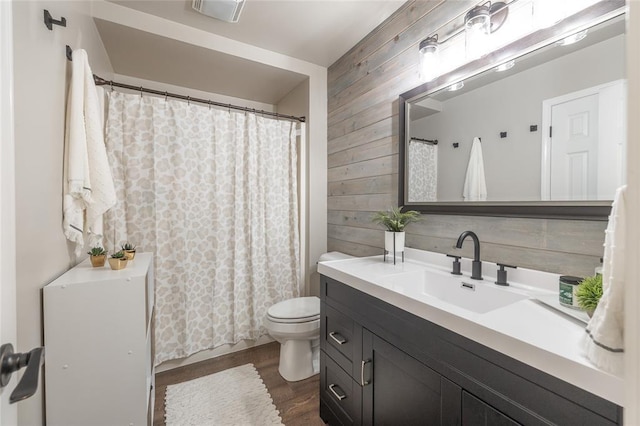 1104 Turkey Run, Rolla, MO 65401 - full bath featuring wooden walls, vanity, toilet, wood finished floors, and curtained shower