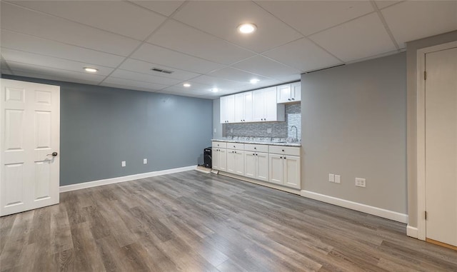 1104 Turkey Run, Rolla, MO 65401 - bar area with wood finished floors, baseboards, backsplash, recessed lighting, and a sink