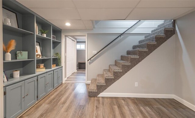 1104 Turkey Run, Rolla, MO 65401 - staircase with baseboards, wood finished floors, recessed lighting, and a paneled ceiling