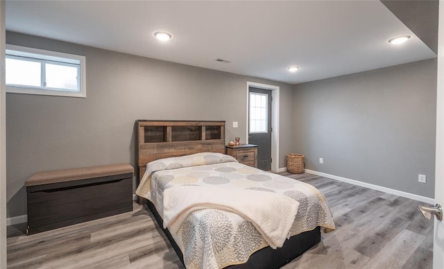 1104 Turkey Run, Rolla, MO 65401 - bedroom with multiple windows, light wood-style floors, baseboards, and recessed lighting
