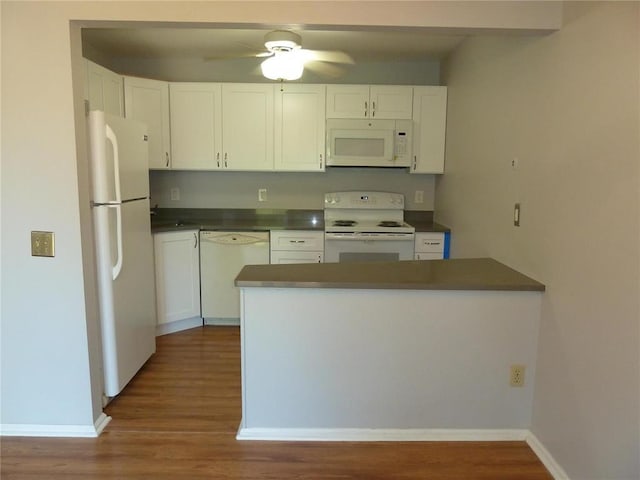 1133 Appleseed Ln Unit B, Saint Louis, MO 63132 - kitchen featuring white appliances, dark countertops, white cabinetry, and wood finished floors