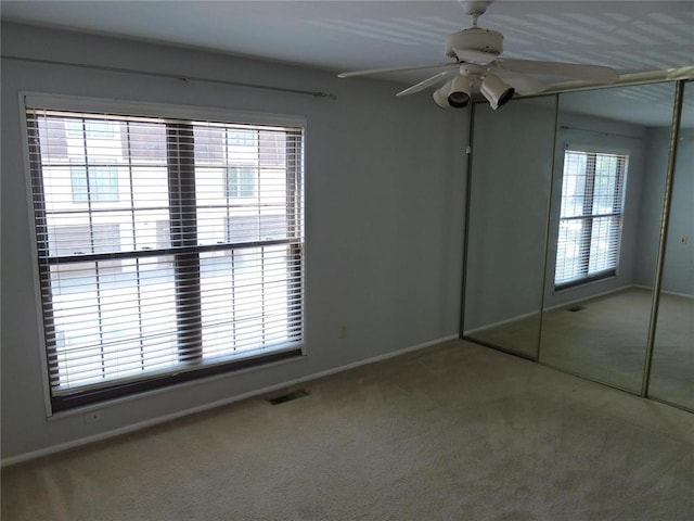 1133 Appleseed Ln Unit B, Saint Louis, MO 63132 - unfurnished bedroom with carpet flooring, baseboards, and multiple windows