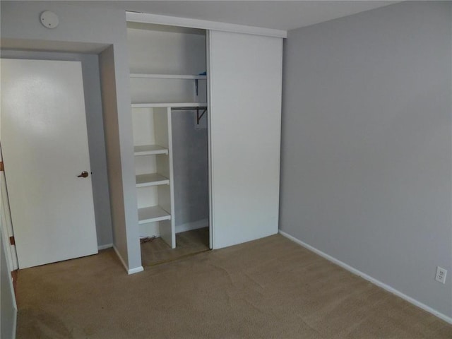 1133 Appleseed Ln Unit B, Saint Louis, MO 63132 - unfurnished bedroom featuring carpet flooring, a closet, and baseboards