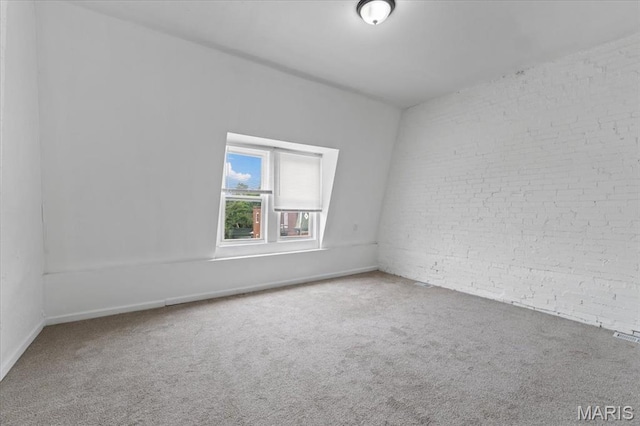 3124 Oregon Ave, Saint Louis, MO 63118 - empty room with carpet flooring, brick wall, and baseboards