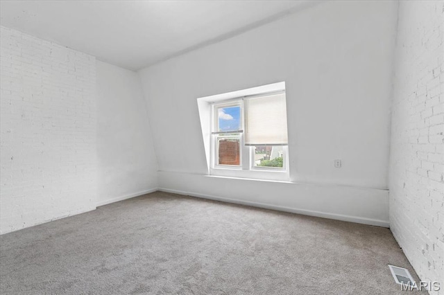 3124 Oregon Ave, Saint Louis, MO 63118 - spare room with carpet flooring and brick wall