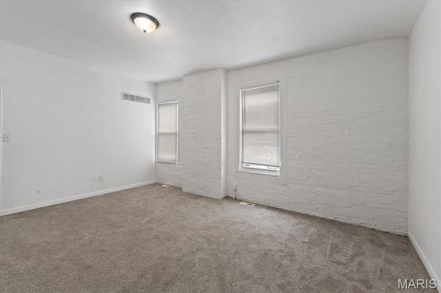3124 Oregon Ave, Saint Louis, MO 63118 - empty room with carpet flooring, brick wall, and baseboards