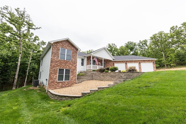 11475 Slate Cir, Rolla, MO 65401 - view of front of house featuring brick siding, central air condition unit, a front yard, and driveway