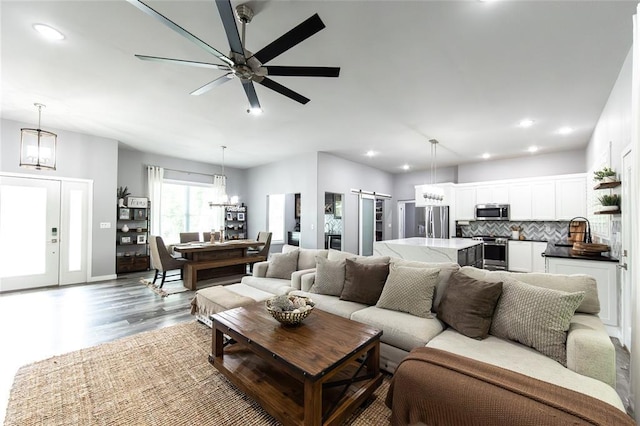 11475 Slate Cir, Rolla, MO 65401 - living room with a barn door, wood finished floors, a chandelier, recessed lighting, and ceiling fan