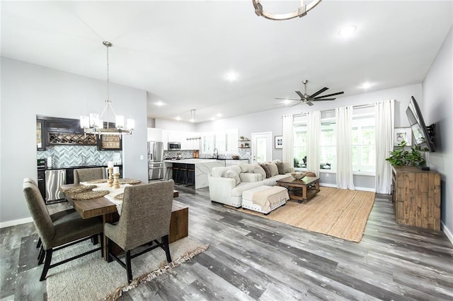 11475 Slate Cir, Rolla, MO 65401 - dining room with a chandelier, dark wood-style flooring, a ceiling fan, recessed lighting, and baseboards