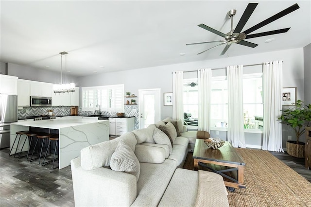 11475 Slate Cir, Rolla, MO 65401 - living area featuring a ceiling fan, dark wood-style floors, and a chandelier