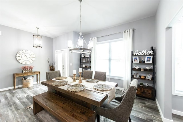 11475 Slate Cir, Rolla, MO 65401 - dining room featuring a chandelier, wood finished floors, and baseboards