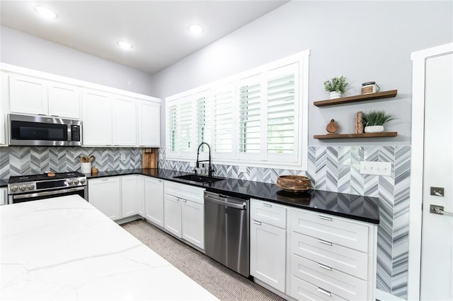 11475 Slate Cir, Rolla, MO 65401 - kitchen featuring appliances with stainless steel finishes, a sink, dark stone countertops, open shelves, and white cabinetry
