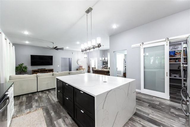 11475 Slate Cir, Rolla, MO 65401 - kitchen with dark cabinets, dark wood-style floors, a ceiling fan, light stone countertops, and pendant lighting