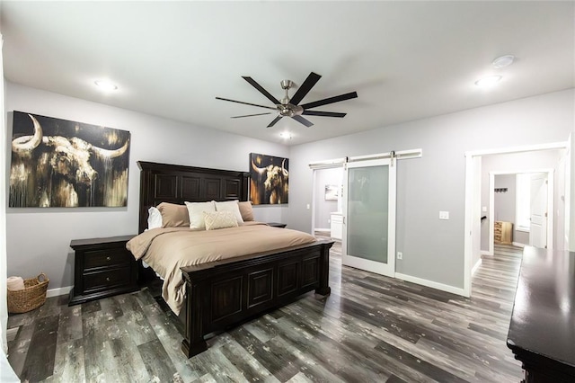 11475 Slate Cir, Rolla, MO 65401 - bedroom with a barn door, wood finished floors, baseboards, a ceiling fan, and ensuite bathroom