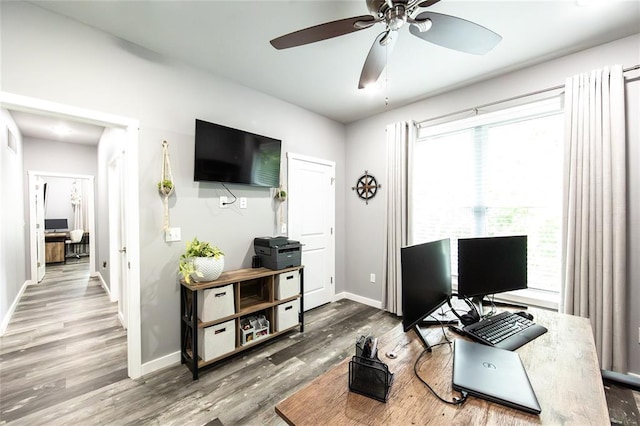 11475 Slate Cir, Rolla, MO 65401 - office area featuring healthy amount of natural light, wood finished floors, ceiling fan, and baseboards