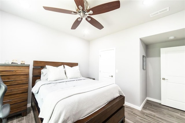 11475 Slate Cir, Rolla, MO 65401 - bedroom featuring baseboards, wood finished floors, and ceiling fan