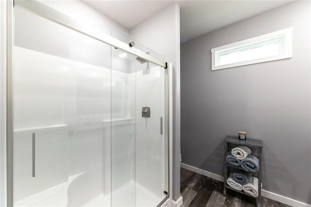 11475 Slate Cir, Rolla, MO 65401 - bathroom with a stall shower, wood finished floors, and baseboards