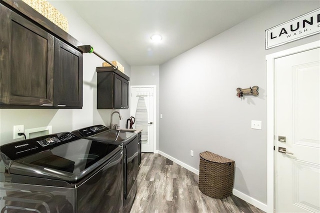11475 Slate Cir, Rolla, MO 65401 - washroom featuring cabinet space, independent washer and dryer, wood finished floors, and baseboards