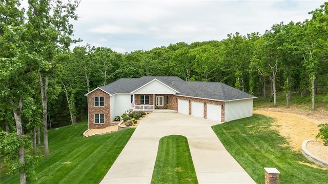 11475 Slate Cir, Rolla, MO 65401 - single story home with driveway, brick siding, an attached garage, a front yard, and a wooded view
