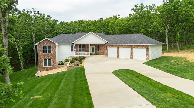 11475 Slate Cir, Rolla, MO 65401 - view of front facade with brick siding, driveway, an attached garage, and a porch