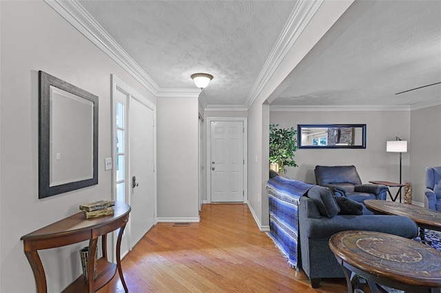 5810 Sorrel Tree Ct, Saint Louis, MO 63129 - entryway with light wood-style flooring, baseboards, a textured ceiling, and ornamental molding