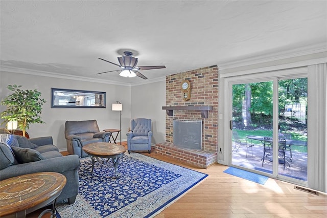 5810 Sorrel Tree Ct, Saint Louis, MO 63129 - living room featuring ceiling fan, wood finished floors, crown molding, and a brick fireplace