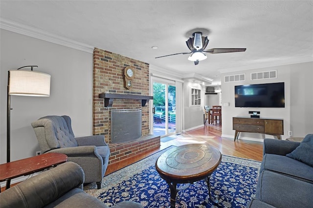 5810 Sorrel Tree Ct, Saint Louis, MO 63129 - living room featuring a ceiling fan, wood finished floors, ornamental molding, baseboards, and a brick fireplace