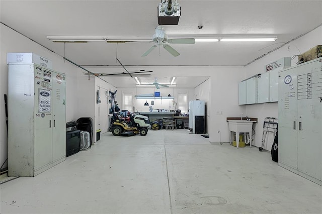 5810 Sorrel Tree Ct, Saint Louis, MO 63129 - garage featuring a sink, a garage door opener, ceiling fan, and freestanding refrigerator