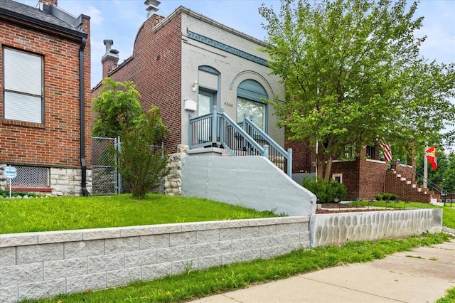 4366 Swan Ave, Saint Louis, MO 63110 - view of front of house featuring brick siding and a gate