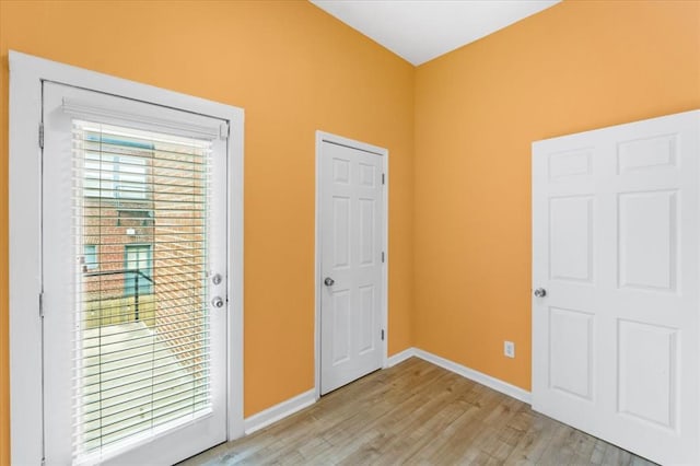 4366 Swan Ave, Saint Louis, MO 63110 - unfurnished bedroom with light wood finished floors and baseboards