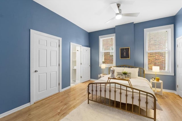 4366 Swan Ave, Saint Louis, MO 63110 - bedroom with light wood-style floors, baseboards, ensuite bathroom, and ceiling fan