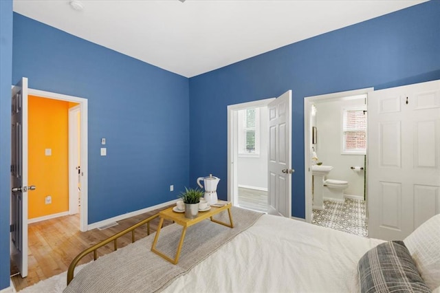 4366 Swan Ave, Saint Louis, MO 63110 - bedroom with baseboards and ensuite bath