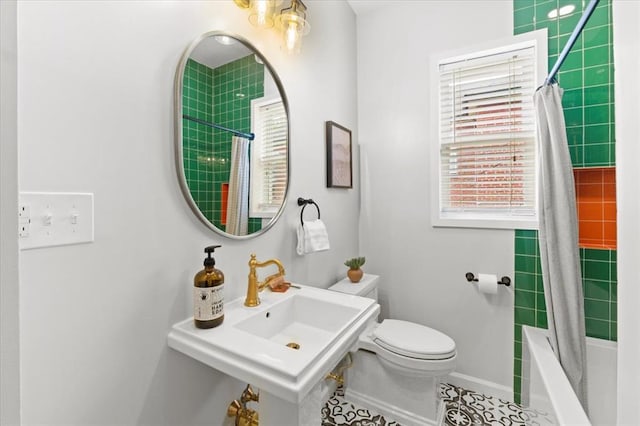 4366 Swan Ave, Saint Louis, MO 63110 - bathroom with toilet, shower / bath combo with shower curtain, baseboards, and tile patterned floors