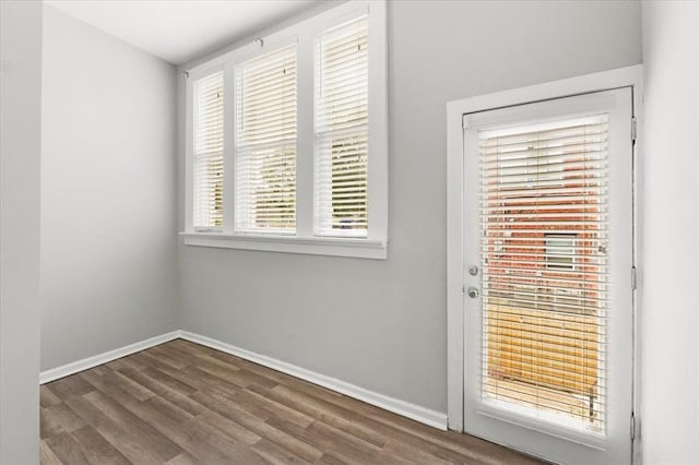 4366 Swan Ave, Saint Louis, MO 63110 - doorway to outside featuring wood finished floors and baseboards
