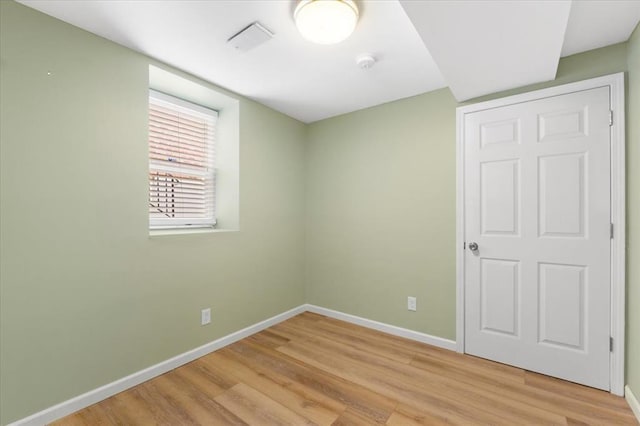 4366 Swan Ave, Saint Louis, MO 63110 - unfurnished bedroom featuring baseboards and light wood finished floors