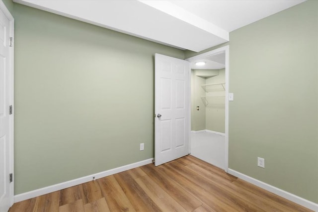 4366 Swan Ave, Saint Louis, MO 63110 - unfurnished bedroom featuring wood finished floors, baseboards, and recessed lighting