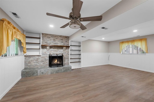 5 Braquewood Ct, Manchester, MO 63021 - unfurnished living room with a ceiling fan, wainscoting, healthy amount of natural light, wood finished floors, and a fireplace