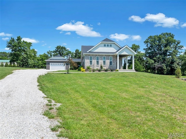 125 Foxwoods Ct, Troy, MO 63379 - craftsman house featuring gravel driveway, a front yard, a garage, and brick siding