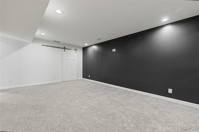 125 Foxwoods Ct, Troy, MO 63379 - carpeted empty room featuring a barn door and recessed lighting