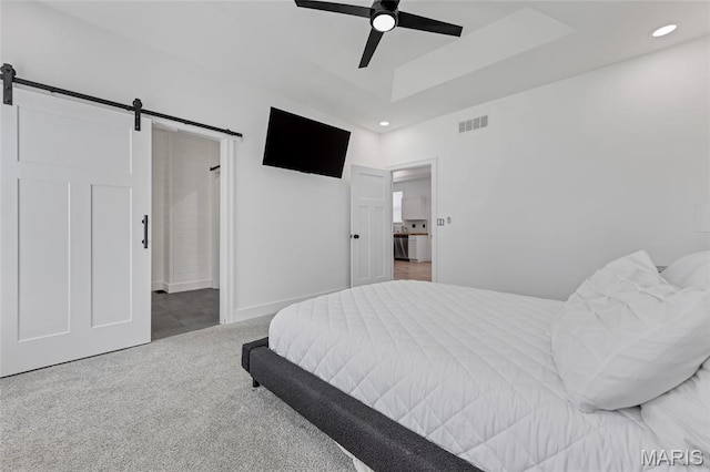 125 Foxwoods Ct, Troy, MO 63379 - bedroom with a barn door, carpet floors, a raised ceiling, recessed lighting, and a ceiling fan