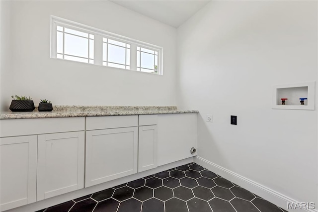125 Foxwoods Ct, Troy, MO 63379 - washroom with electric dryer hookup, cabinet space, hookup for a washing machine, and dark tile patterned floors