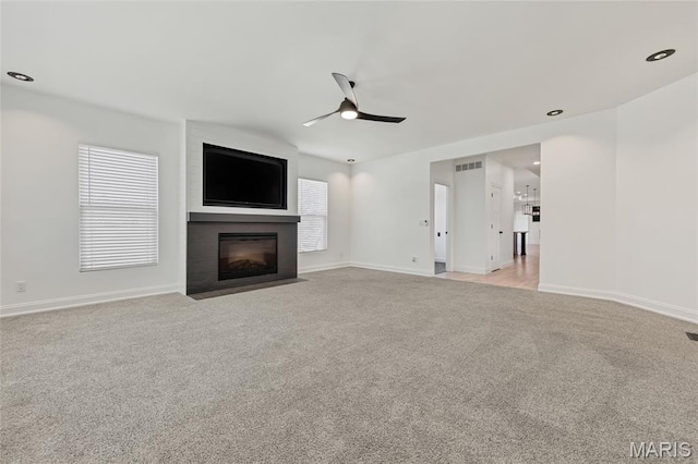 125 Foxwoods Ct, Troy, MO 63379 - unfurnished living room featuring carpet, ceiling fan, a large fireplace, and recessed lighting