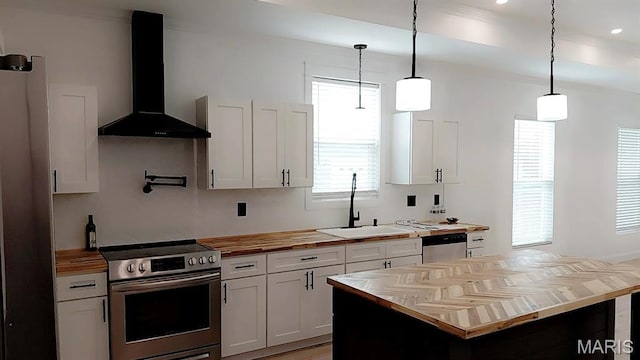 125 Foxwoods Ct, Troy, MO 63379 - kitchen with appliances with stainless steel finishes, butcher block counters, wall chimney range hood, pendant lighting, and white cabinetry