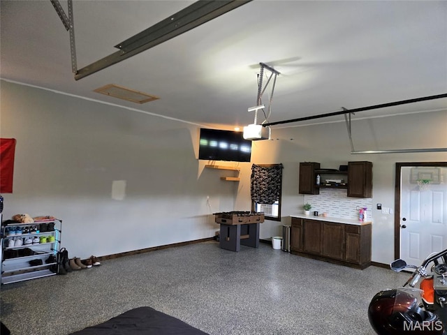 125 Foxwoods Ct, Troy, MO 63379 - garage with baseboards and a garage door opener