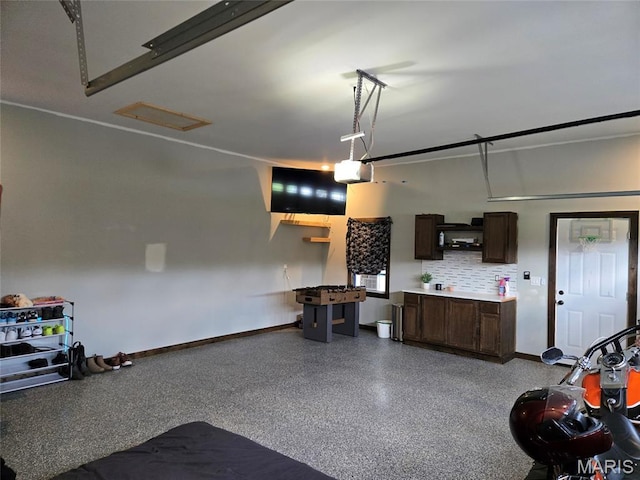 125 Foxwoods Ct, Troy, MO 63379 - garage with baseboards and a garage door opener