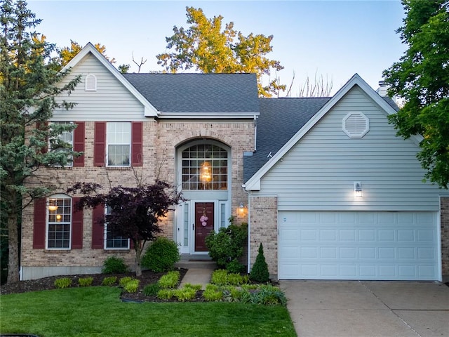 3226 Bridgeport Place Dr, Bridgeton, MO 63044 - view of front facade with brick siding, driveway, a front yard, and a shingled roof