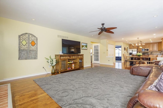 3226 Bridgeport Place Dr, Bridgeton, MO 63044 - living room with baseboards, ceiling fan, a chandelier, light wood finished floors, and recessed lighting
