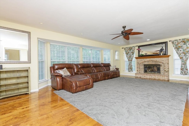 3226 Bridgeport Place Dr, Bridgeton, MO 63044 - living room with ceiling fan, wood finished floors, baseboards, a fireplace, and recessed lighting