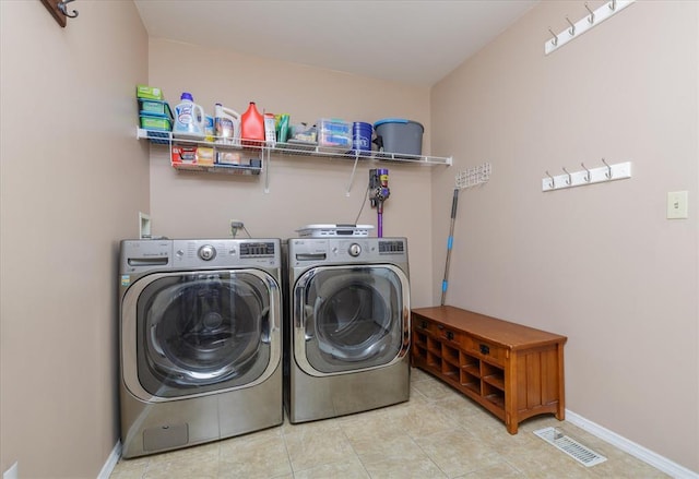 3226 Bridgeport Place Dr, Bridgeton, MO 63044 - laundry area featuring independent washer and dryer, tile patterned flooring, and baseboards