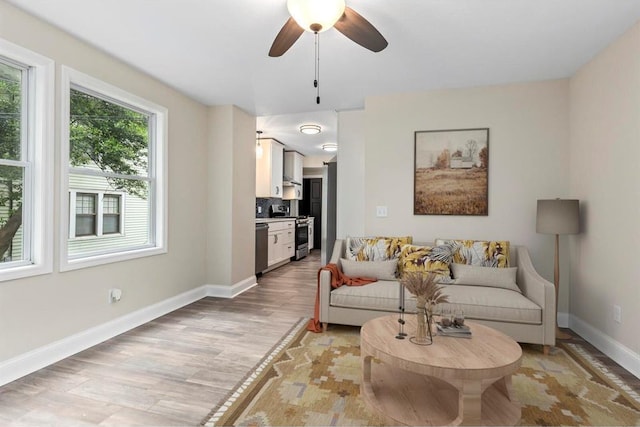 426 Pasadena Ave, Webster Groves, MO 63119 - living area featuring light wood finished floors, ceiling fan, and baseboards